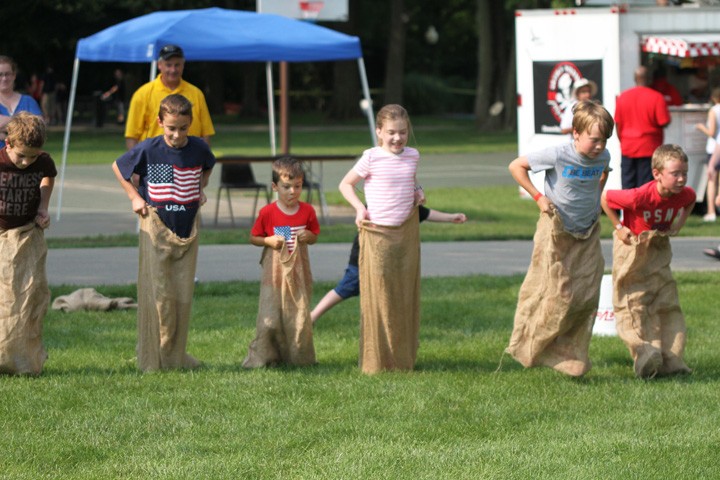 The boys and girls club of Zionsville sponsored kid activities including a sack race at this years 4th of July celebration in Lions Park. (Photo by Keith Shepherd)