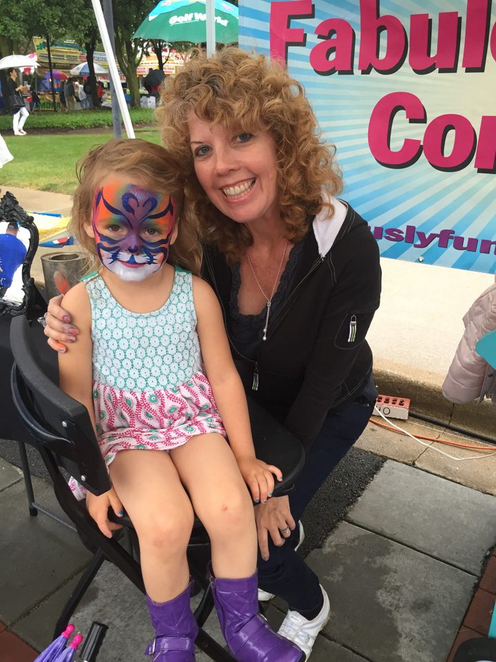 Arya Frizzell gets her face painted by Adrienne Maynard of Fabulously Fun Company. (Photo by Anna Skinner)