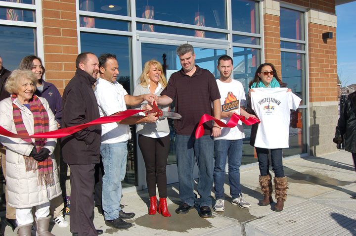 Flamme Burger co-owners Henri Najem and his wife, Shelley, cut the ribbon during the grand opening with general manager Jim Shields and Town of Whitestown officials. (photo by Heather Lusk)