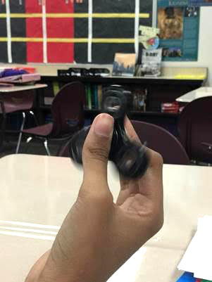 A student uses a fidget spinner during class at Carmel Middle School. Fidgets are available in a variety of shapes, sizes and textures. (Submitted photo)