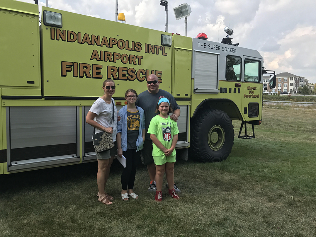 Fishers firefighter Tony Baskerville and his wife, Becky, and children, Olivia and Ava, at Carmel Public Safety Day. Departments from across the state brought vehicles and equipment for the family-friend public safety event.