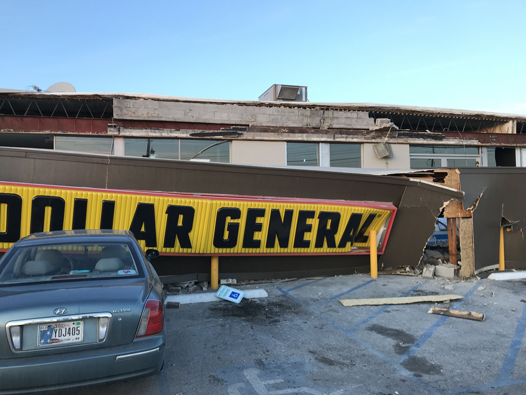 The façade of a building that housed Dollar General and an insurance firm at 8050 Pendleton Pike collapsed at approximately 4:15 p.m. Dec. 11. Three cars were damaged in the collapse. (Submitted photo)