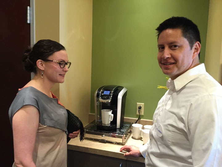 Amy Contreras, the interior designer for Expedite, and Abel Contreras, her guest wait for coffee at the open house.